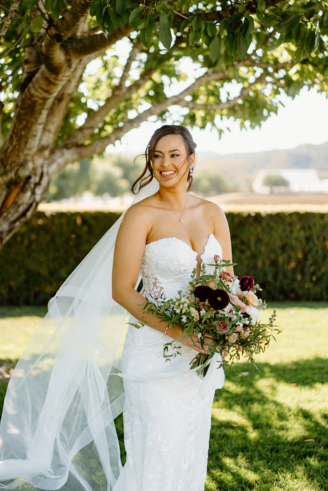 Bride looks off in distance at The White Barn in San Luis Obispo CA, photography by Cobblestone
