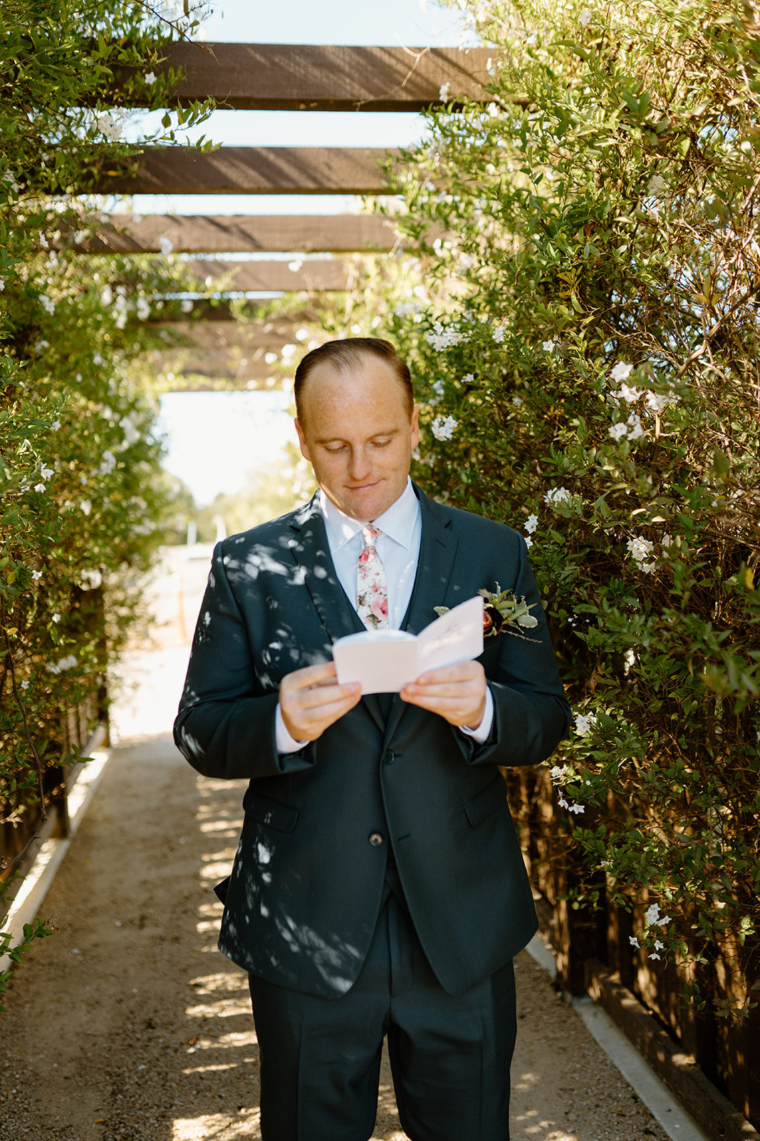 Groom reads letter from bride at The White Barn in San Luis Obispo CA, photography by Cobblestone
