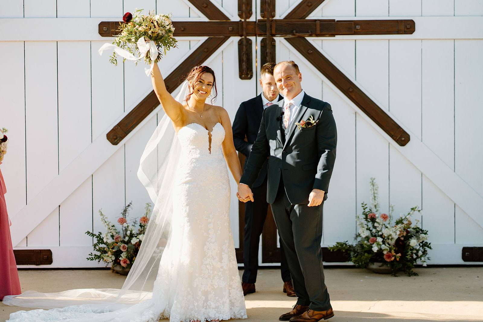 Bride and groom at alter cheer at The White Barn in San Luis Obispo CA, photography by Cobblestone