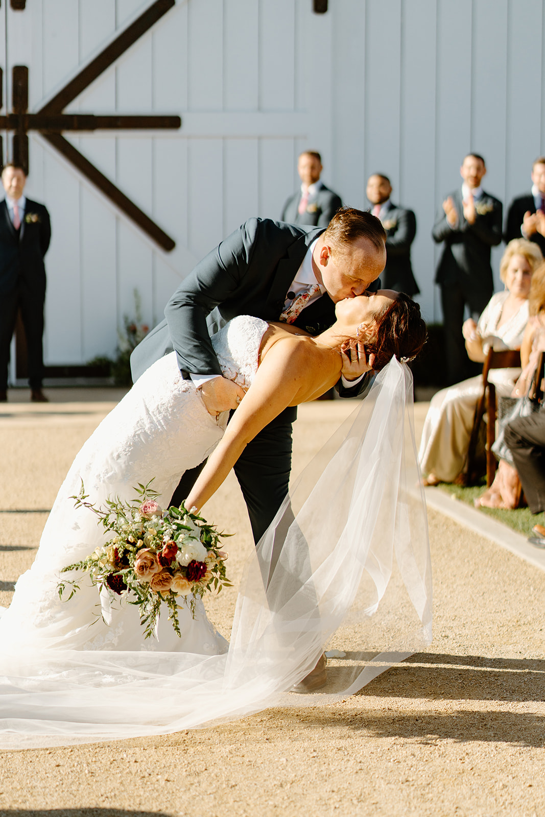 Bride and groom kiss after wedding at The White Barn in San Luis Obispo CA, photography by Cobblestone