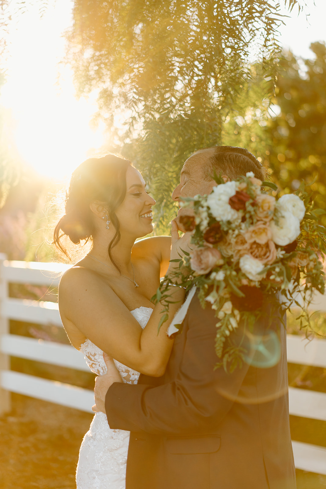 Bride and groom lean in to kiss at The White Barn in San Luis Obispo CA, photography by Cobblestone
